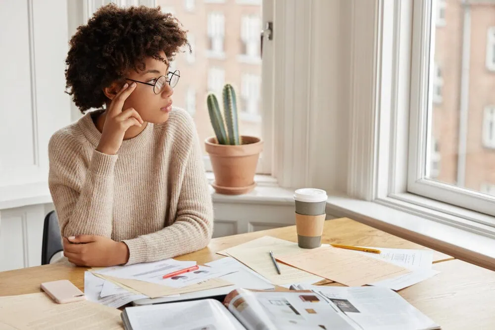 anxiety counselling in vancouver woman sitting at table looking outside