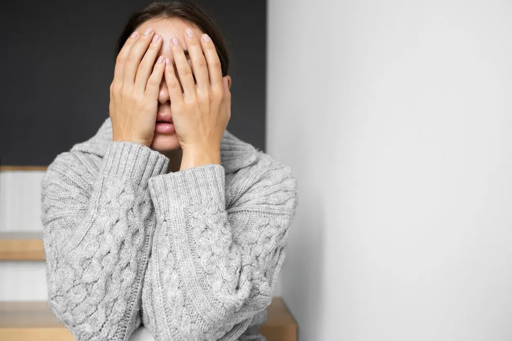 anxiety counselling woman with hands in front of her face